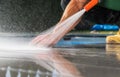 Homeowner Cleaning Patio Poolside Deck