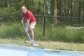 Homeowner cleaning swimming pool