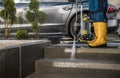 Homeowner Washing His Garden Paths and Driveway Using Pressure Washer Royalty Free Stock Photo