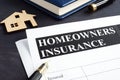Homeowners insurance policy and model of home. Royalty Free Stock Photo