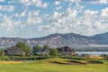 Homes amid a golf course pond and lake with view of towering mountain and valley Royalty Free Stock Photo