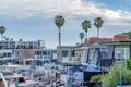 Homes with private docks against palm trees and overcast sky in Huntington Beach Royalty Free Stock Photo