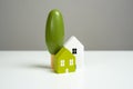 Homes and real estate. House and decorative trees, figurines.