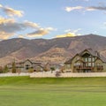 Homes with white fence and near a huge mountain Royalty Free Stock Photo