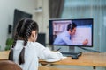 Homeschool Asian little young girl learning online class from school teacher by digital remote meeting due covid19 pandemic. Kid Royalty Free Stock Photo