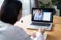 Homeschool Caucasian cute young girl student learning virtual internet online class from school teacher by remote meeting due to c Royalty Free Stock Photo