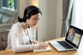 Homeschool Caucasian cute young girl student learning virtual internet online class from school teacher by remote meeting due to c Royalty Free Stock Photo