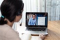 Homeschool Caucasian cute young girl student learning virtual internet online class from school teacher by remote meeting due to c Royalty Free Stock Photo