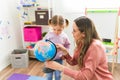 Homeschool mom talking with a little girl about the planet Royalty Free Stock Photo