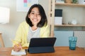 Homeschooling Asian girl doing homework And study online with tablet at the desk night. Portrait of Asia child happiness and