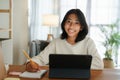 Homeschooling Asian girl doing homework And study online with tablet at the desk night. Portrait of Asia child happiness and