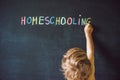 Homeschooling. Child pointing at word Homeschooling on a blackboard Royalty Free Stock Photo