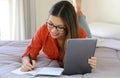 Homeschooling, e-learning, smart school, distant education concept. Smiling student girl wearing glasses studying online