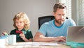 homeschooling and elearning. back to school. serious father and son use computer at home. Royalty Free Stock Photo