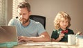 homeschooling and elearning. back to school. serious father and son use computer at home. Royalty Free Stock Photo