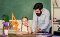 Homeschooling with father. School teacher and schoolgirl. Man bearded pedagogue. Strict pedagogue. Pedagogue skills