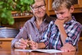 Homeschooling grandmother teaching smart boy, child