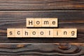 Homeschooling word written on wood block. Home schooling text on table, concept Royalty Free Stock Photo