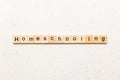 Homeschooling word written on wood block. Homeschooling text on cement table for your desing, Top view concept Royalty Free Stock Photo