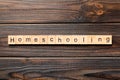 Homeschooling word written on wood block. Homeschooling text on wooden table for your desing, Top view concept Royalty Free Stock Photo