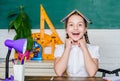 Hometask concept. Girl cute child sit school classroom chalkboard background. Small kid study school. Progress and