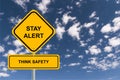 Stay alert think safety traffic sign on blue sky