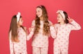 Homewear and pyjamas for girls. Happy kids in homewear. Holding hands and giving V-sign gesture Royalty Free Stock Photo