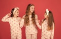 Homewear and pyjamas for girls. Happy kids in homewear. Holding hands and giving V-sign gesture Royalty Free Stock Photo