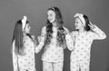 Homewear and pyjamas for girls. Happy kids in homewear. Holding hands and giving V-sign gesture Royalty Free Stock Photo