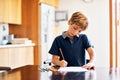 Homework helps to develop positive study skills and habits. a young boy doing his homework.