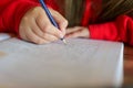 Homework.schoolgirl does her homework.pencil in a childs hand writes words in a notebook.Study and education. child