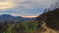 Homolje mountains landscape with a winding gravel country road at sunset of an autumn sunny day Royalty Free Stock Photo