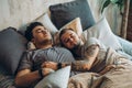 A homosexual couple on bed in studio with loft interior Royalty Free Stock Photo