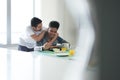 Gay Couple Eating Breakfast At Home In the Morning Royalty Free Stock Photo