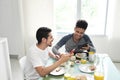 Gay Couple Eating Breakfast At Home In the Morning Royalty Free Stock Photo