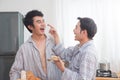 Homosexual couple prepairing breakfast in kitchen together