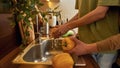 Homosexual male couple washing vegetables in kitchen Royalty Free Stock Photo