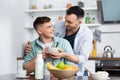 homosexual man holding bowl near husband Royalty Free Stock Photo