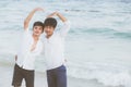 Homosexual portrait young asian couple stand gesture heart shape together on beach in summer Royalty Free Stock Photo