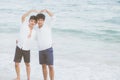 Homosexual portrait young asian couple stand gesture heart shape together on beach in summer Royalty Free Stock Photo