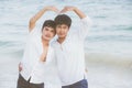 Homosexual portrait young asian couple stand gesture heart shape together on beach in summer Royalty Free Stock Photo