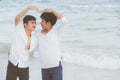 Homosexual portrait young asian couple stand gesture heart shape together on beach in summer Royalty Free Stock Photo