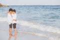 Homosexual portrait young asian couple standing hug together on beach in summer, asia gay going tourism for leisure Royalty Free Stock Photo