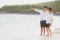 Homosexual portrait young asian couple standing pointing something together on beach in summer Royalty Free Stock Photo