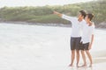 Homosexual portrait young asian couple standing pointing something together on beach in summer Royalty Free Stock Photo