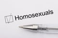 Homosexuals - checkbox with a cross on white paper with pen. Checklist concept Royalty Free Stock Photo