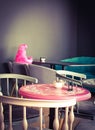Homunculus Loxodontus. The interior of a deserted cafe with a charming pink soft toy sitting alone at a table