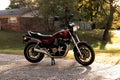 Honda CB 750 Night Hawk Motorcycle parked on a road with tree and house in the background