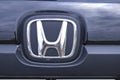 A Honda emblem shot closeup on a car grill with chrome