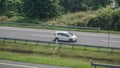 Honda Jazz or Honda Fit driving fast on trans jawa highway Royalty Free Stock Photo